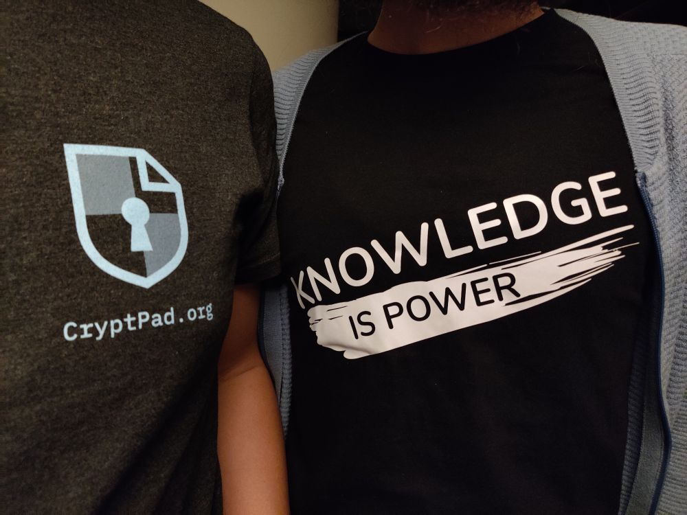 photo of two people wearing a CryptPad and XWiki t-shirts next to each other